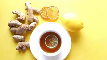 Ginger tea with lemon and ginger on yellow background video