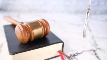 A judge's gavel on a book with a hammer on the table video
