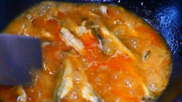 A pan with some fish and sauce in it video