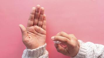 A person holding up their hand to show that they are using a hand sanitizer video