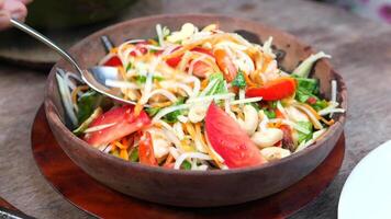 A bowl of salad with a spoon in it video