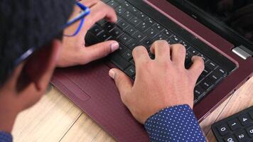 A person typing on a laptop computer video