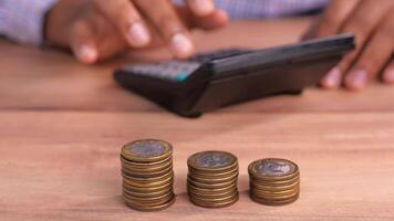 A man is using a calculator to calculate the amount of money he has video