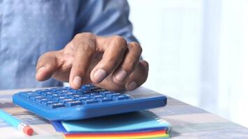 A person is using a calculator on a desk video