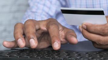 A man holding a credit card and typing on a keyboard video
