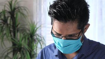 A man wearing a face mask and glasses video