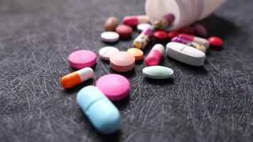 Pills and tablets scattered on a black surface video