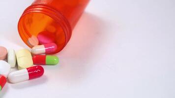 Pills spilling out of an open bottle video