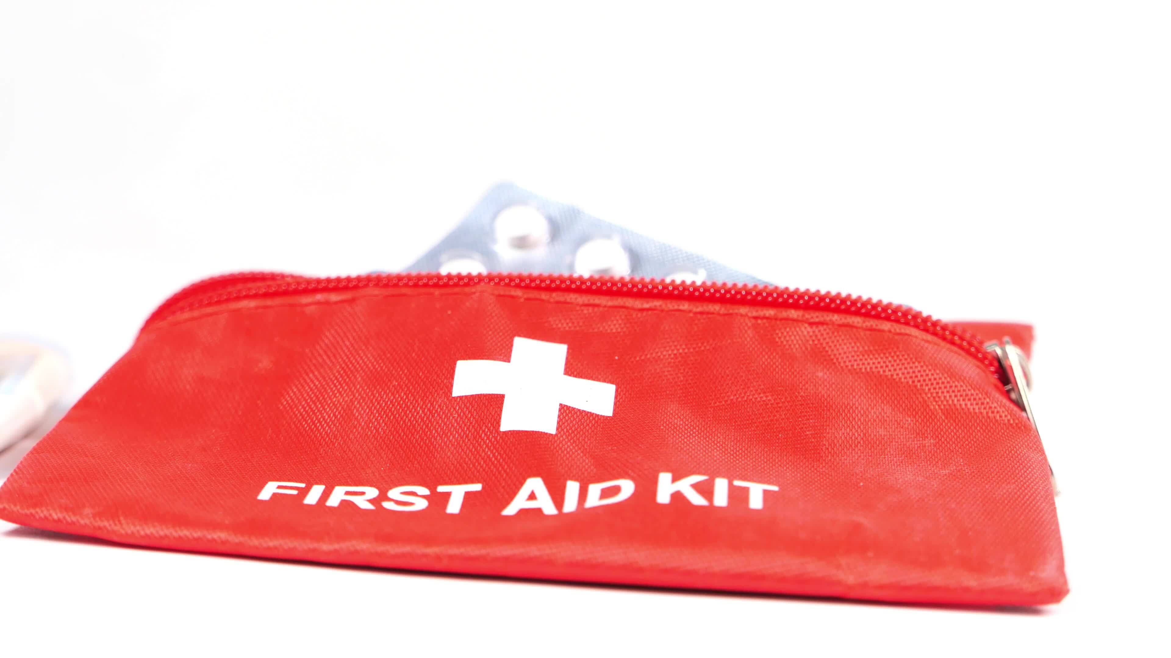 A first aid kit with a red bag and a blue bandage 50012396 Stock Video