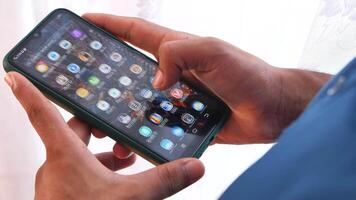 A person holding a smartphone with a screen on it video