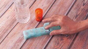 A person is using a pill bottle to open a pill video