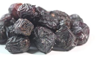 A pile of dried dates on a white background video