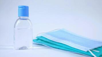 A bottle of hand sanitizer and a blue surgical mask video