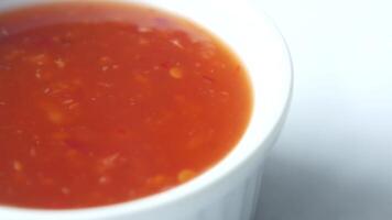 A close up of a bowl of sauce on a white surface video