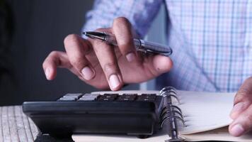 A man is using a calculator to calculate the amount of money he has in his pocket video
