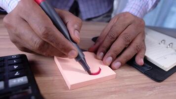 A person is using a pen to write on a piece of paper video