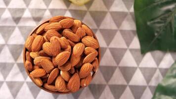 Almonds in a bowl on a table with lemon video