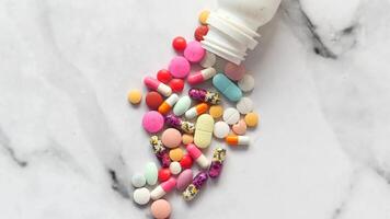 A bottle of pills spilling out onto a marble surface video
