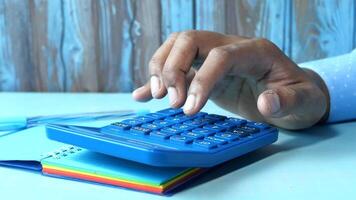 A person using a calculator on a desk video