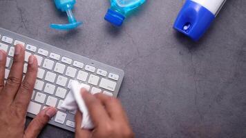 A person typing on a keyboard with a bottle of hand sanitizer next to it video