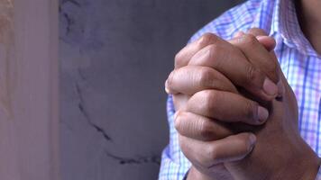 A man is praying in front of a window video