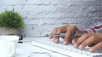A person typing on a keyboard with a cup of coffee video