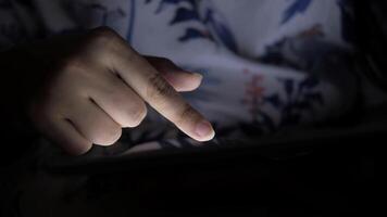 A person holding a tablet with their finger on it video