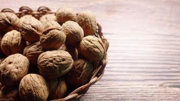 stack of natural walnuts in a bowl on table video