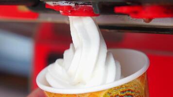 Closeup of Soft Serve Ice Cream Machine Dispensing Vanilla Ice Cream into a Cone video