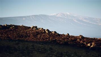 Distant mountain view with rocky foreground during early morning light video