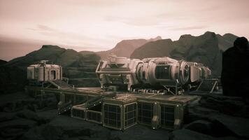 Colonist base on a distant planet with rugged terrain under a hazy sky video