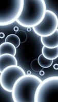 Glowing 3d spiral of balls. Design. Neon circles move in spiral stream on black background. Beautiful 3d spiral with neon circles video