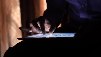 A person is using a tablet computer in the dark video