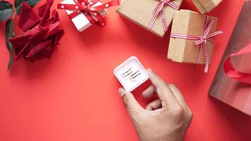Gift box with a heart on it on a red background video