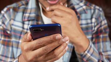 A man is looking at his phone while sitting on a couch video
