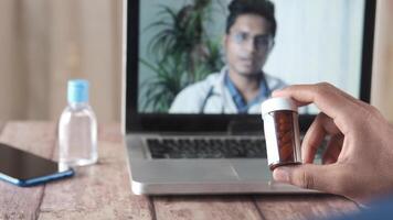 A man is using a tablet to take a call with his doctor video