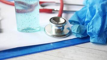 A stethoscope, a bottle of liquid, a pair of gloves and a pair of scissors video