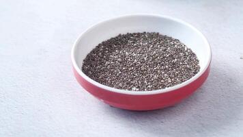 Chia seeds in a bowl on a white surface video