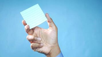 A person holding a piece of paper with a note on it video