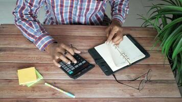 A man is using a calculator on a desk video