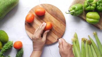 A person cutting up vegetables on a cutting board video