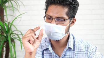 A man wearing a face mask while sitting at a table video
