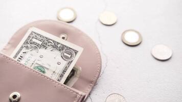 A pink wallet with money inside video