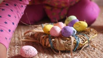 A child is playing with eggs in a nest video