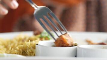 A person is holding a fork over a plate of food video