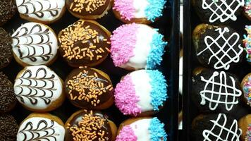 A display of donuts with different colors and designs video