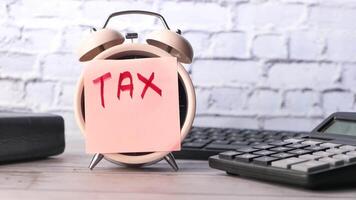 Tax calculator on desk with calculator and calculator video