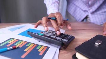 A person is using a calculator to make a financial decision video