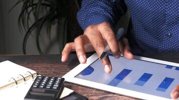 A man is using a tablet with a graph on it video