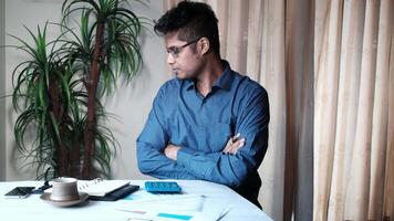 A man sitting at a desk with his arms crossed video